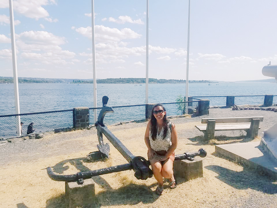 A woman sits on an anchor at the harbor in Oslo