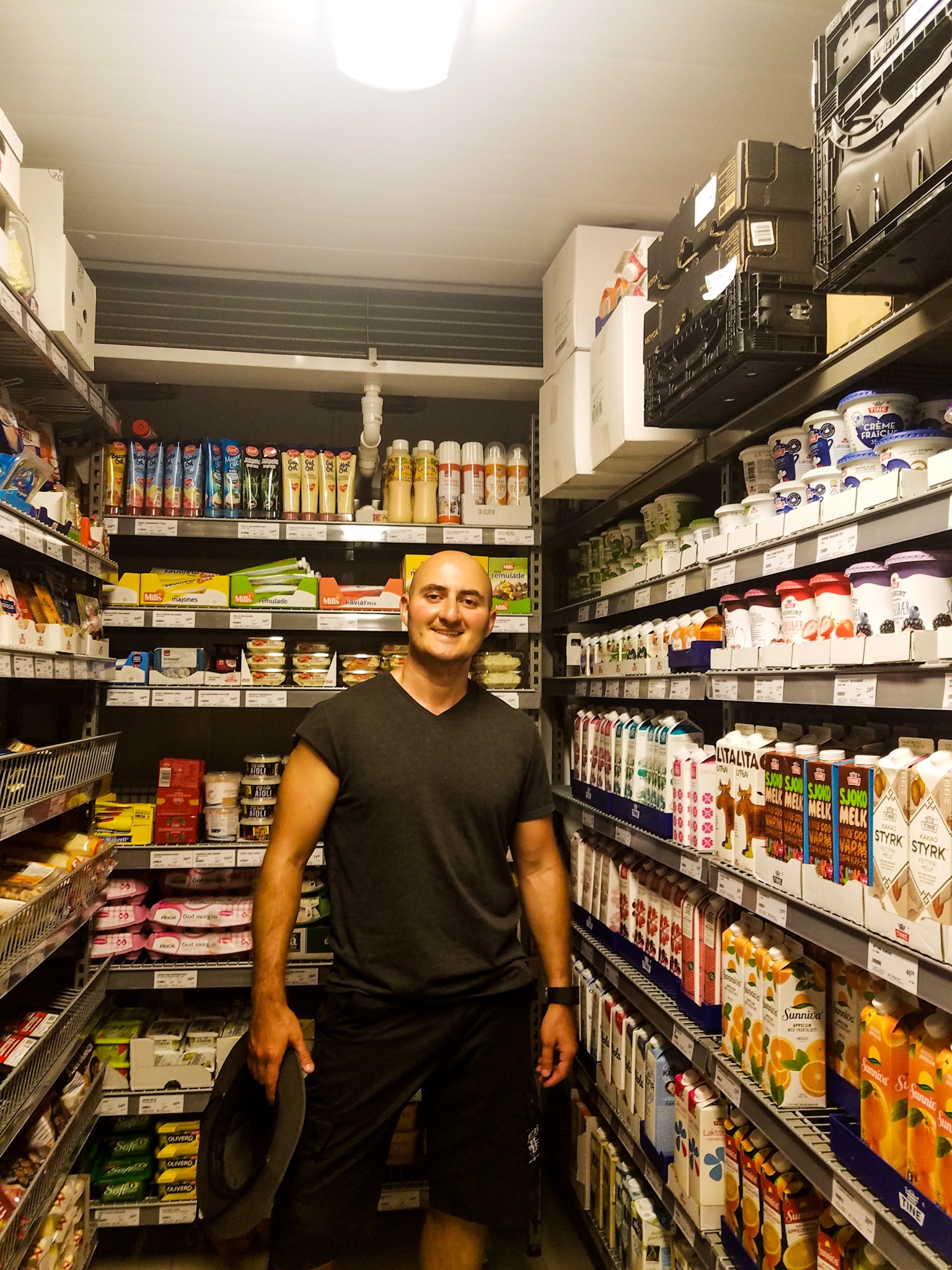 A man stands in the freezer section of a grocery store