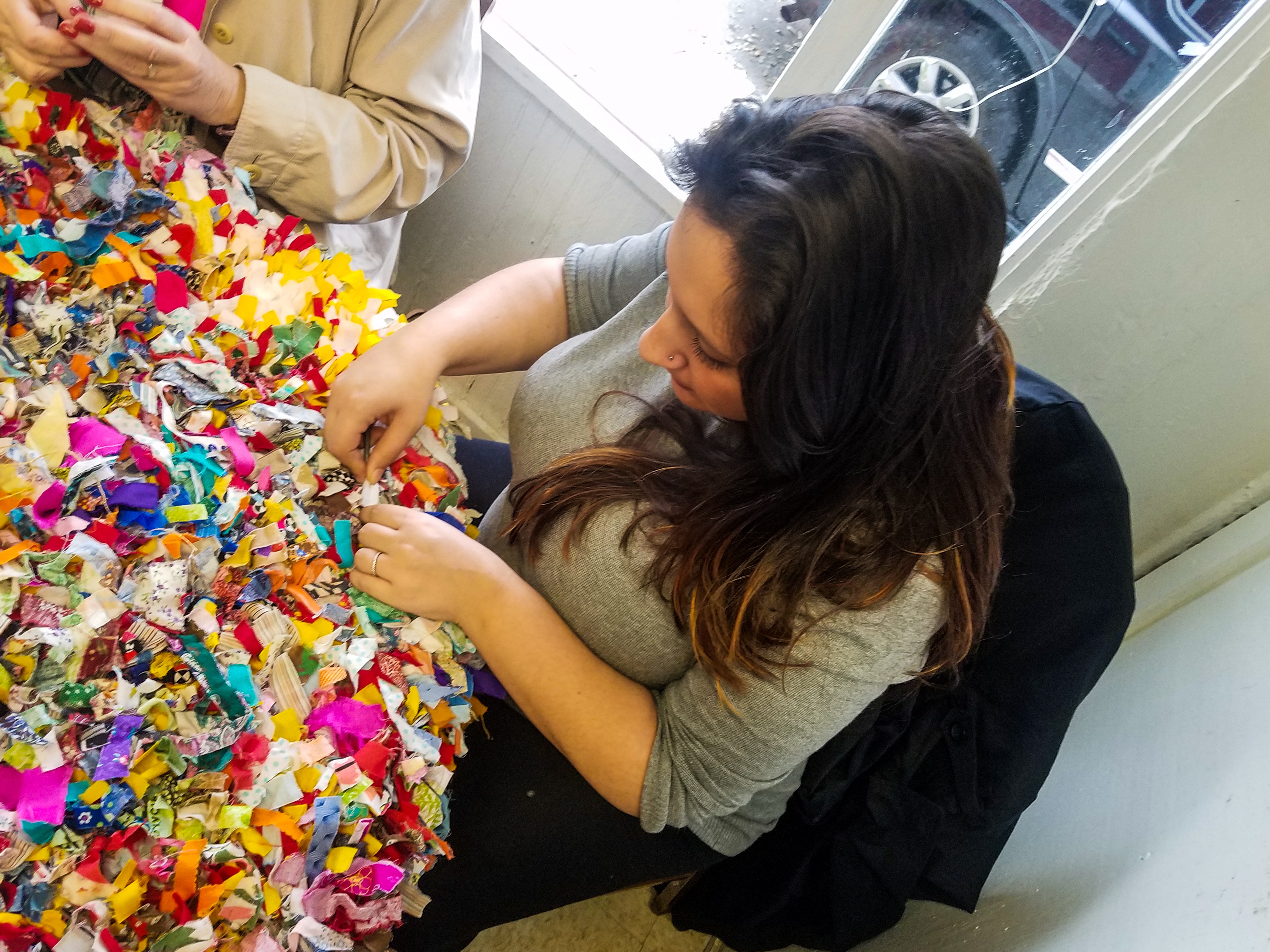 A woman working on a section of a Gullah quilt