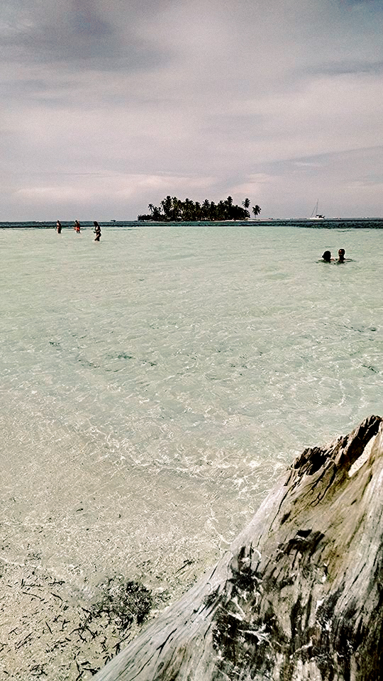 Crystal clear water with an island in the distance