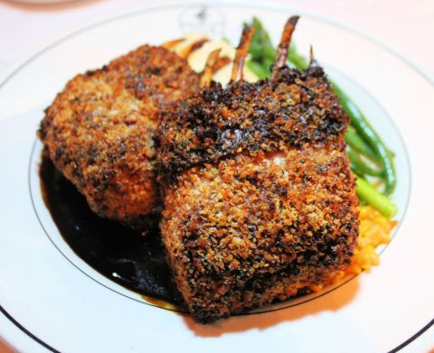 A plate of lamb with asparagus and potatoes